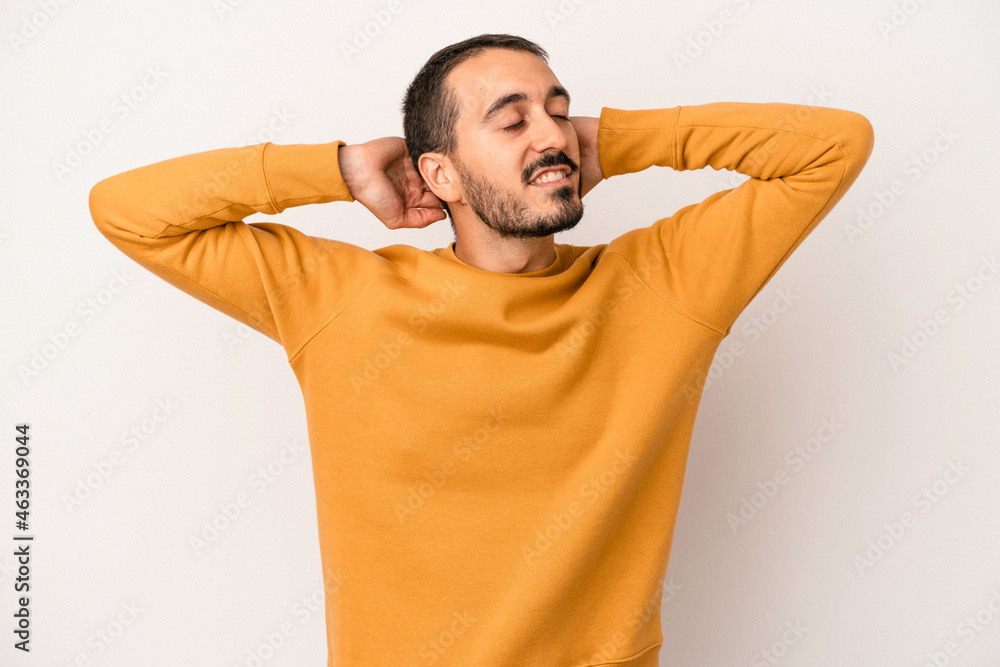 Young caucasian man isolated on white background feeling confident, with hands behind the head. Young caucasian man isolated on white background feeling confident, with hands behind the head.