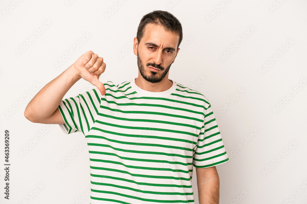 Young caucasian man isolated on white background showing thumb down, disappointment concept. Young caucasian man isolated on white background showing thumb down, disappointment concept.