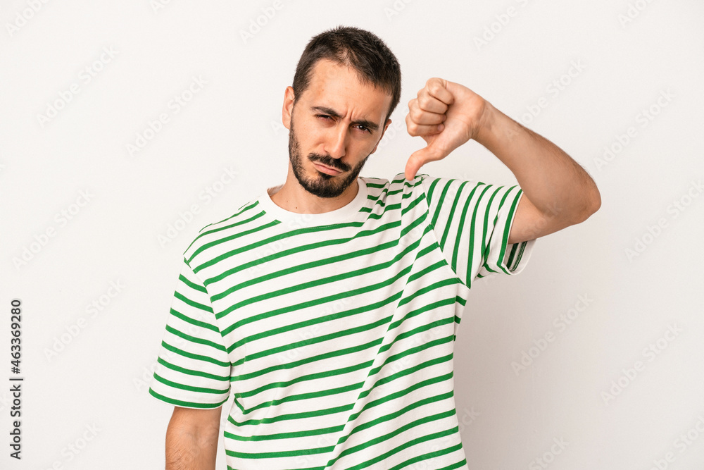 Young caucasian man isolated on white background showing thumb down and expressing dislike. Young caucasian man isolated on white background showing thumb down and expressing dislike.