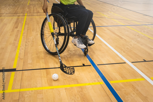 Athlete with disability playing wheelchair hockey with stick. © 24K-Production