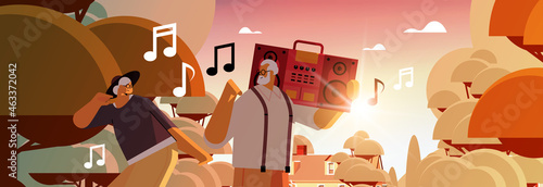 senior family with bass clipping blaster recorder dancing and singing grandparents having fun active old age concept