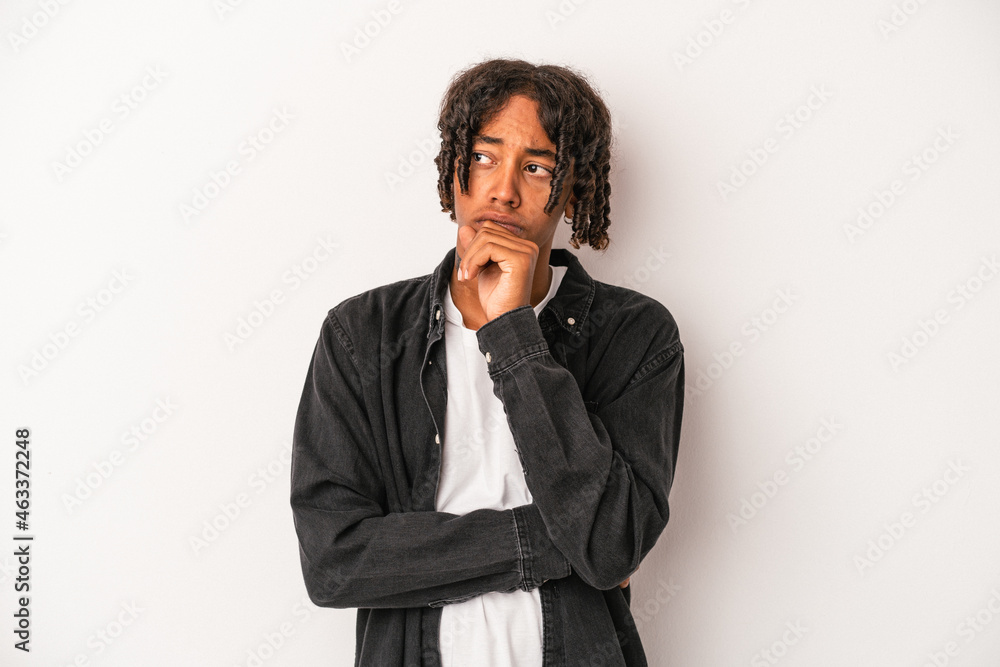 Young african american man isolated on white background confused, feels doubtful and unsure. Young african american man isolated on white background confused, feels doubtful and unsure.