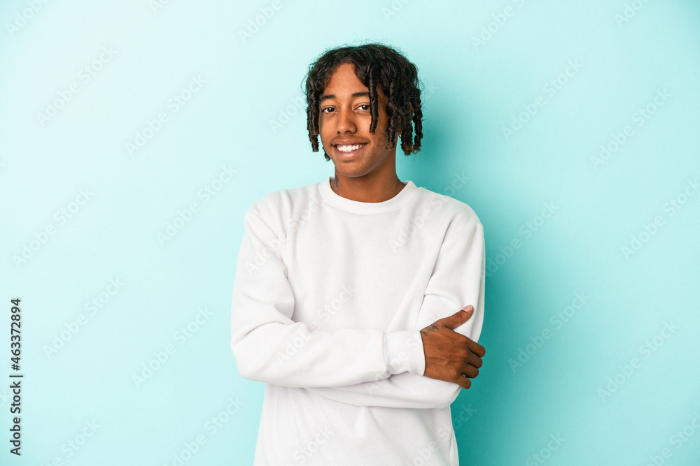 Young african american man isolated on blue background happy, smiling and cheerful. Young african american man isolated on blue background happy, smiling and cheerful.