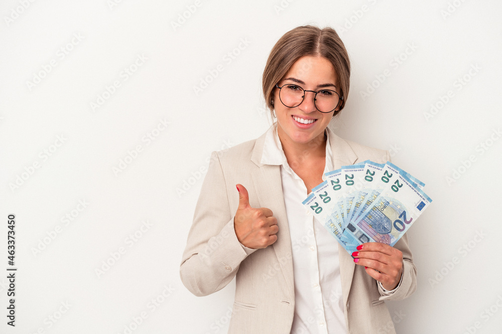 Young Russian business woman holding banknotes isolated on white background smiling and raising thumb up Young Russian business woman holding banknotes isolated on white background smiling and raising thumb up
