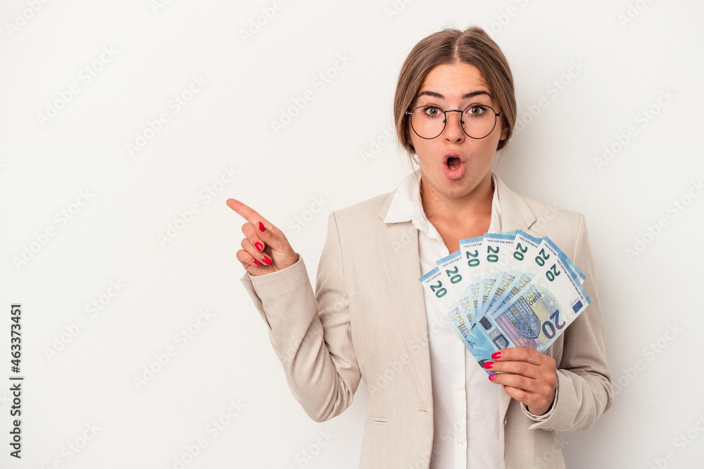 Young Russian business woman holding banknotes isolated on white background pointing to the side Young Russian business woman holding banknotes isolated on white background pointing to the side