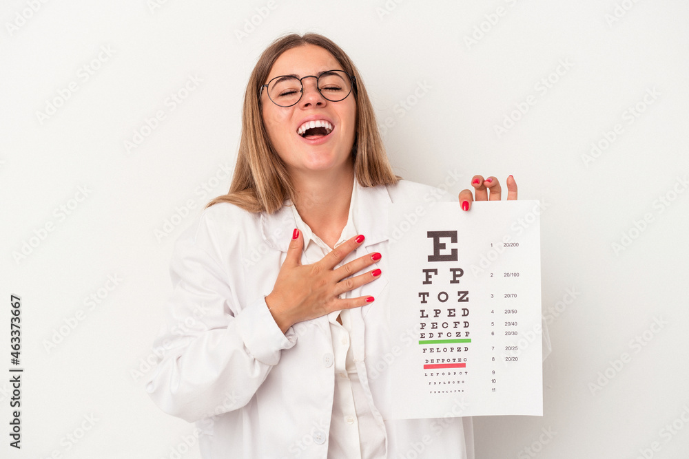 Young optometrist Russian woman isolated on white background laughs out loudly keeping hand on chest.