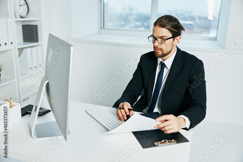man in a suit documents in hand communication by phone Chief