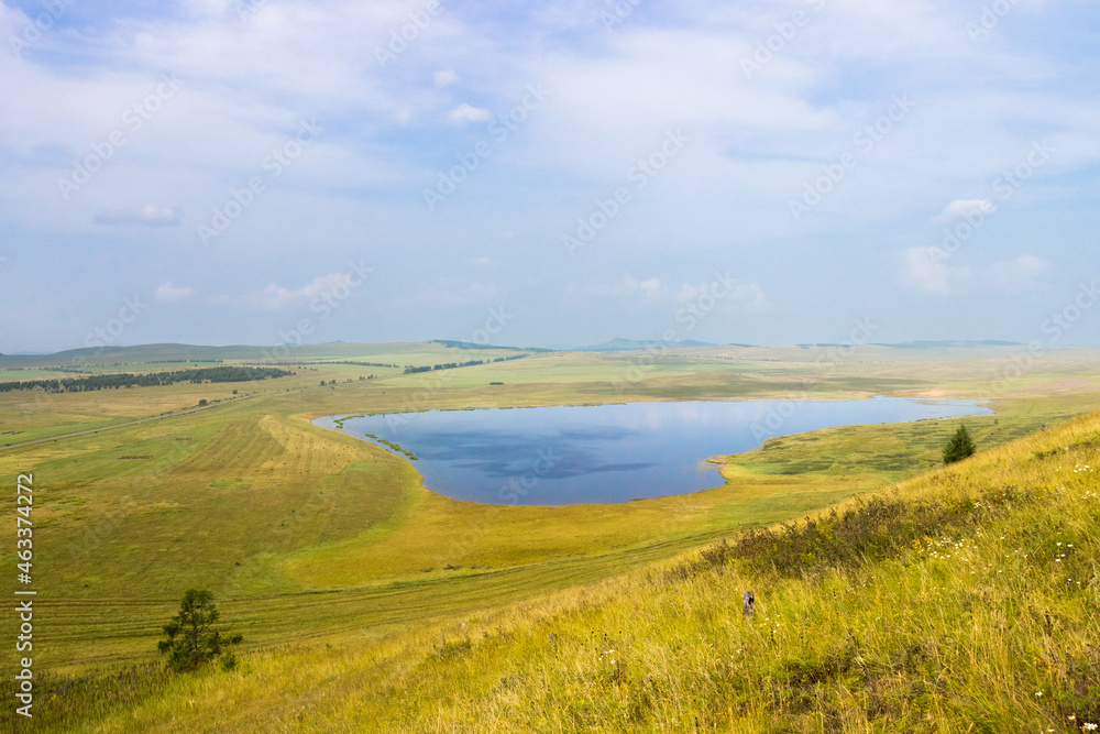 Summer landscape with lake in shape of heart in Khakassia, Russia.