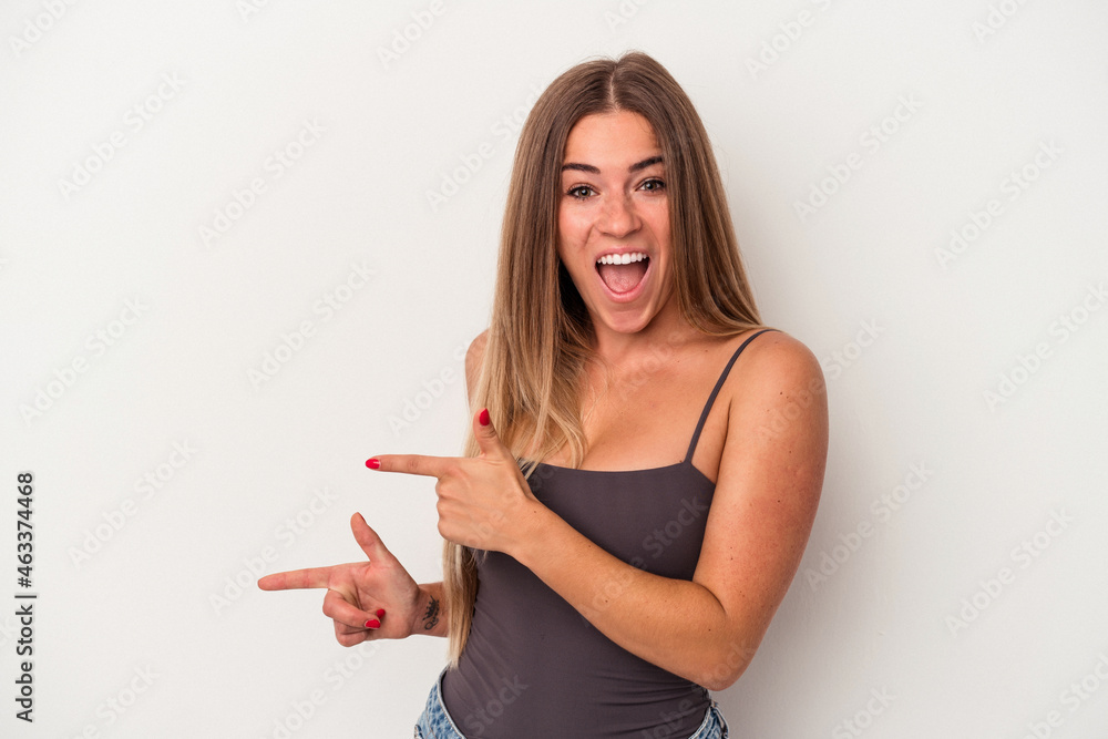 Young Russian woman isolated on white background excited pointing with forefingers away. Young Russian woman isolated on white background excited pointing with forefingers away.