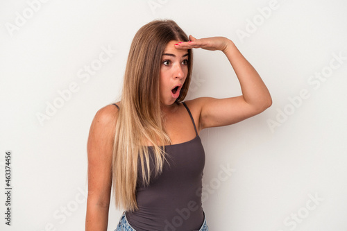 Young Russian woman isolated on white background looking far away keeping hand on forehead.
