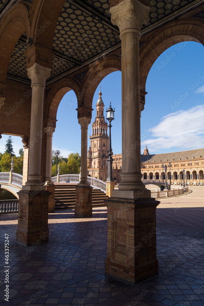 View of the north tower of the Plaza de España from the main building. Architectural complex and emblematic place of the city of Seville known for the beauty of its facade and pillars (Spain).