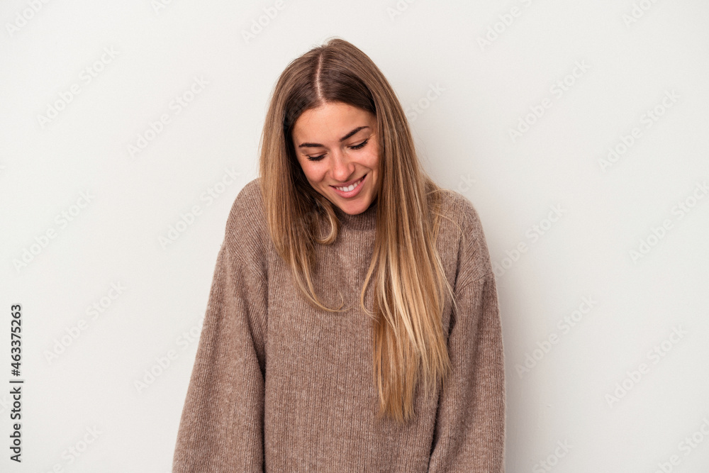 Young Russian woman isolated on white background winks an eye and holds an okay gesture with hand. Young Russian woman isolated on white background winks an eye and holds an okay gesture with hand.