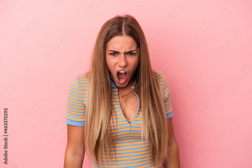 Young Russian woman isolated on pink background is saying a secret hot braking news and looking aside Young Russian woman isolated on pink background is saying a secret hot braking news and looking aside