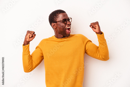 Young African American man isolated on white background raising fist after a victory, winner concept.