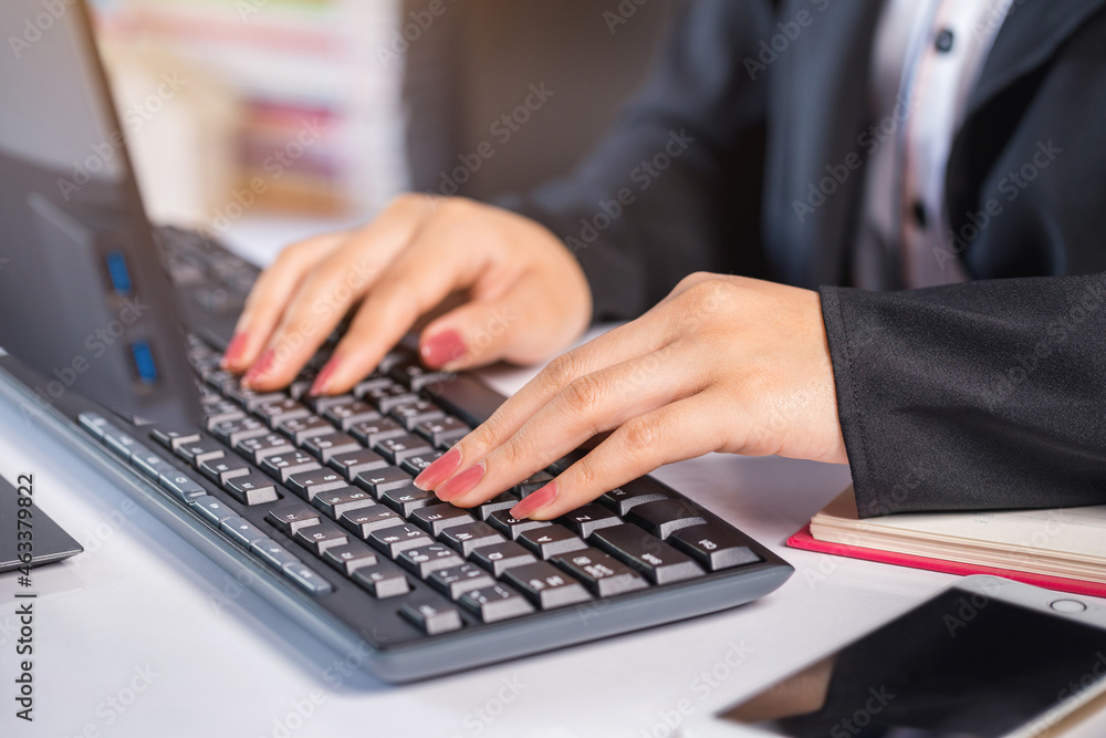 Close-up woman's hand typing on keyboard computer, businesswoman working in the office. Close-up woman's hand typing on keyboard computer, businesswoman working in the office.