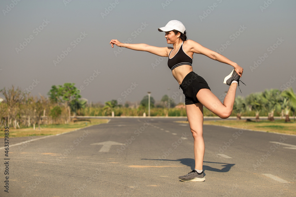 Healthy young Asian woman doing exercises in the morning happily in the park, outdoor Healthy young Asian woman doing exercises in the morning happily in the park, outdoor