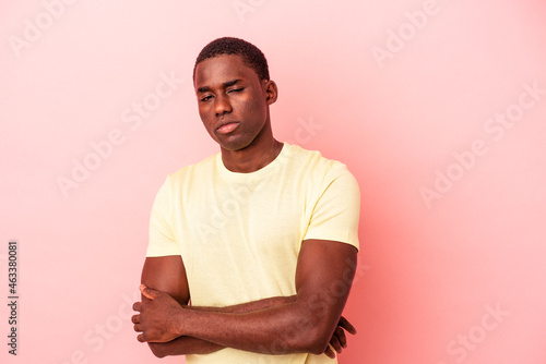 Young African American man isolated on pink background unhappy looking in camera with sarcastic expression.