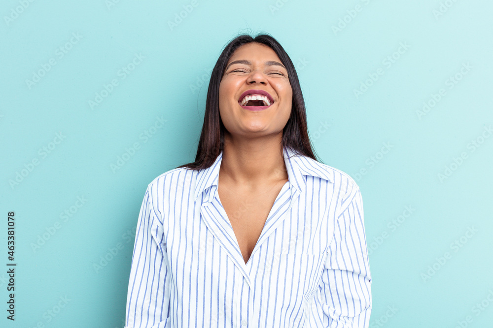 Fototapeta premium Young Venezuelan woman isolated on blue background relaxed and happy laughing, neck stretched showing teeth.
