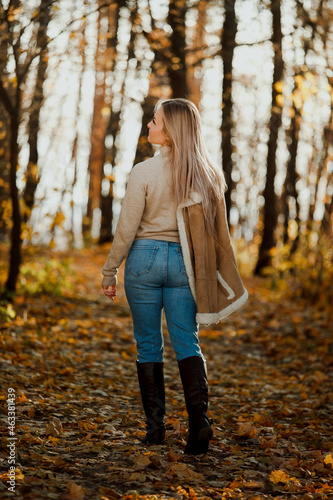  a blonde adult girl walks in the autumn forest. a walk in the fresh air alone © KseniyaK