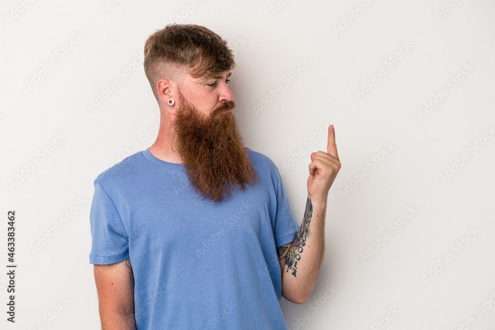 Young caucasian ginger man with long beard isolated on white background pointing with finger at you as if inviting come closer. Young caucasian ginger man with long beard isolated on white background pointing with finger at you as if inviting come closer.