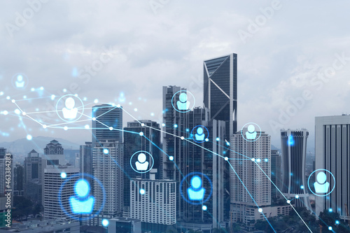 Social media icons hologram over panorama city view of Kuala Lumpur  Malaysia  Asia. The concept of people networking  connections and career opportunities. Double exposure.