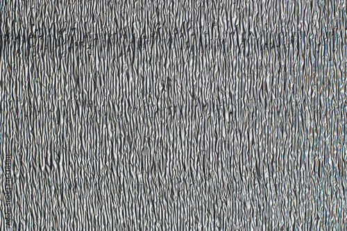 Surface texture of reflective metallic insulation material.