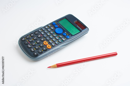 mathematical calculator and red pencil 