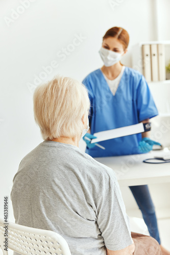 elderly woman and doctor professional examination medical masks