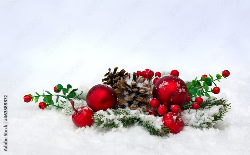 Christmas decoration. Cone pine, twigs christmas tree, red berries, red balls, apples on snow with space for text Christmas decoration. Cone pine, twigs christmas tree, red berries, red balls, apples on snow with space for text