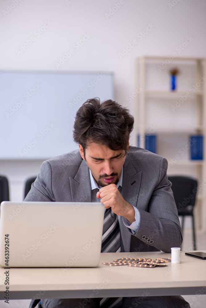 Young businessman employee suffering at workplace Young businessman employee suffering at workplace