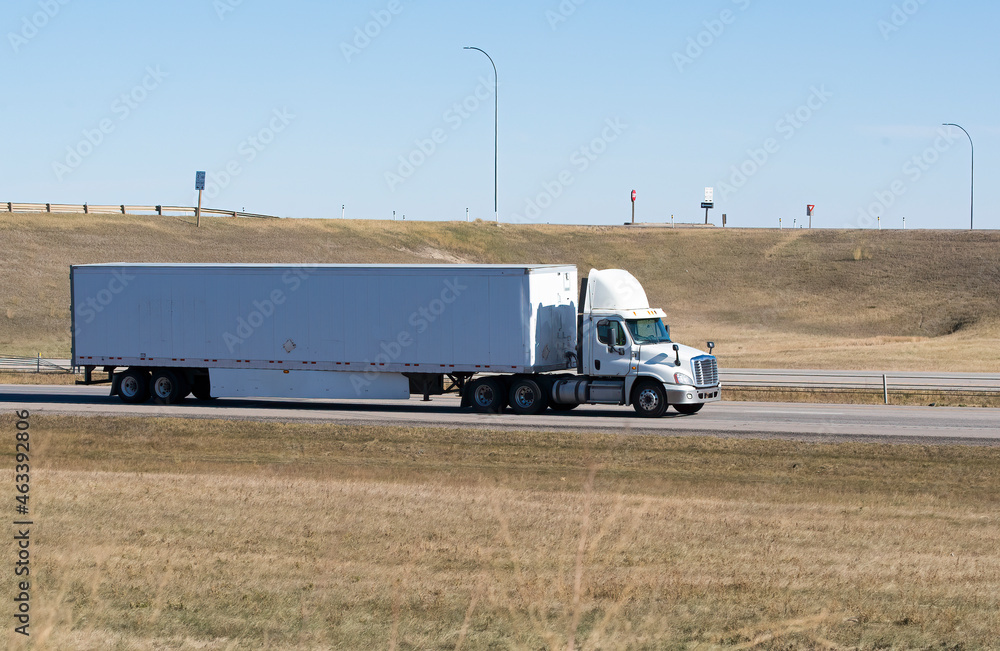 Heavy Cargo on the Road. A truck hauling freight along a highway Heavy Cargo on the Road. A truck hauling freight along a highway