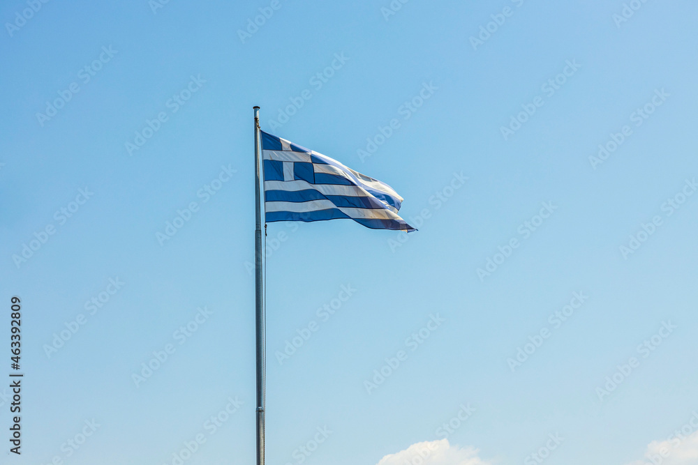 Close up view of Greece flag on blue sky background. Greece.