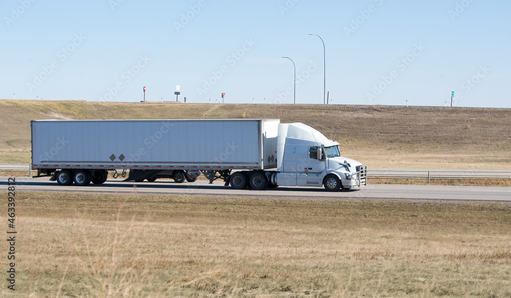 Heavy Cargo on the Road. A truck hauling freight along a highway Heavy Cargo on the Road. A truck hauling freight along a highway