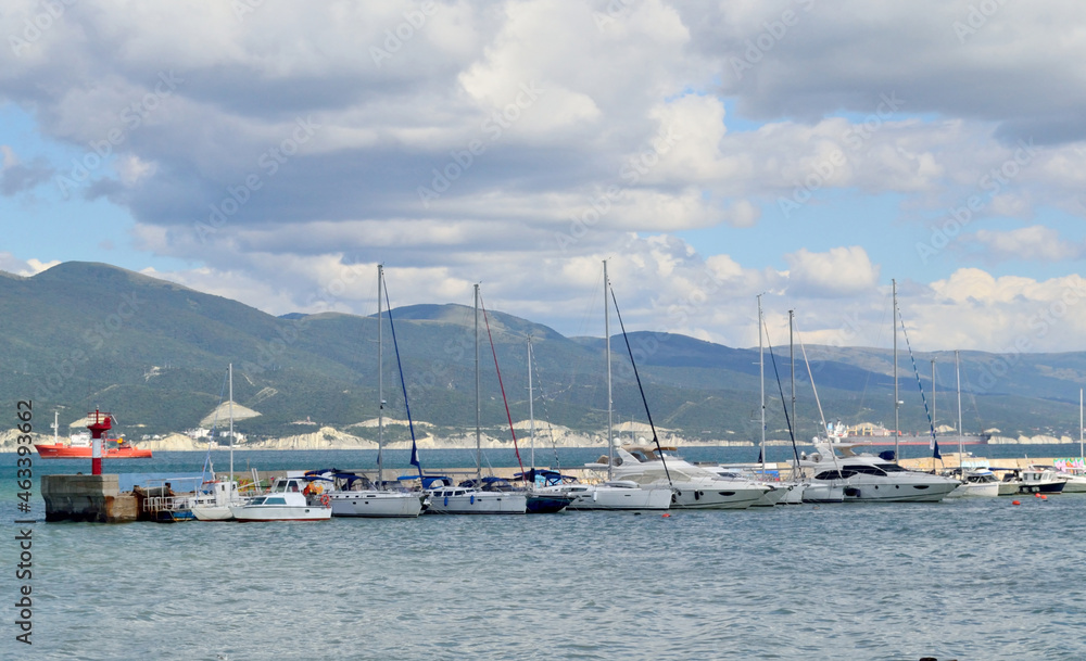 many different yachts are moored on the sea bay