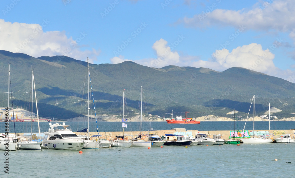 many yachts are moored on the sea bay, prepared for a sailing trip