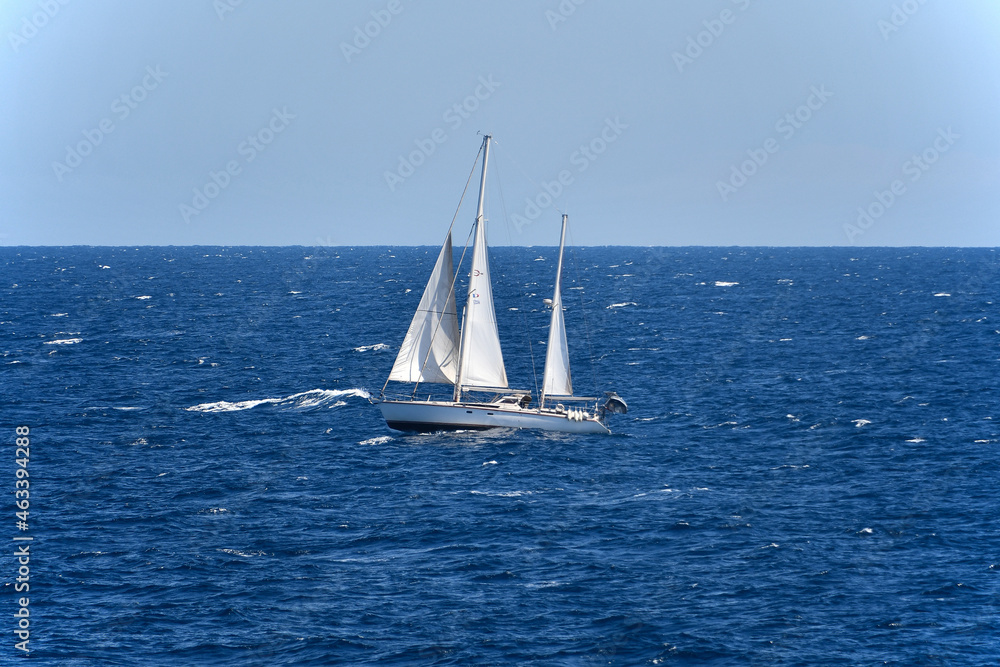 Beautiful white sailboat sailing in the Mediterranean near Corsica.
