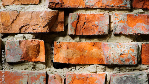 red old brick wall background, brick wall texture, structure. old broken brick, cement joints, close-up. crumbling from old age. macro photo. construction, repair. concept of devastation, decline