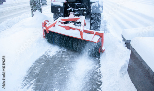 Snowblower cleans sidewalks. Russian Winter. Workers remove snow from the sidewalks. Russian Winter. Snow removal.