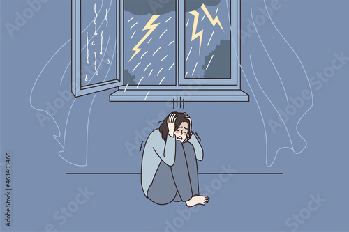 Anxious woman hide cover ears afraid scared of thunderstorm at home. Worried distressed female feel terrified frightened by thunder, have astraphobia. Anxiety, panic attack. Vector illustration.  photo