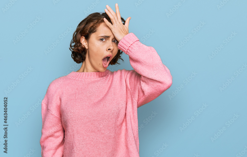 Fototapeta premium Young hispanic woman wearing casual clothes surprised with hand on head for mistake, remember error. forgot, bad memory concept.