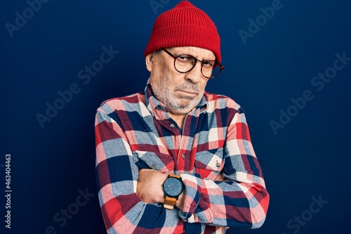 Handsome mature man wearing hipster look with wool cap skeptic and nervous, disapproving expression on face with crossed arms. negative person. © Krakenimages.com