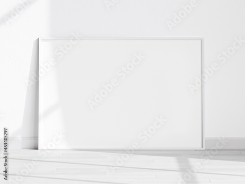 horizontal white frame mockup on the wooden floor