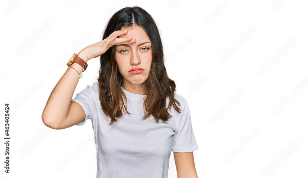 Young beautiful woman wearing casual white t shirt worried and stressed about a problem with hand on forehead, nervous and anxious for crisis Young beautiful woman wearing casual white t shirt worried and stressed about a problem with hand on forehead, nervous and anxious for crisis