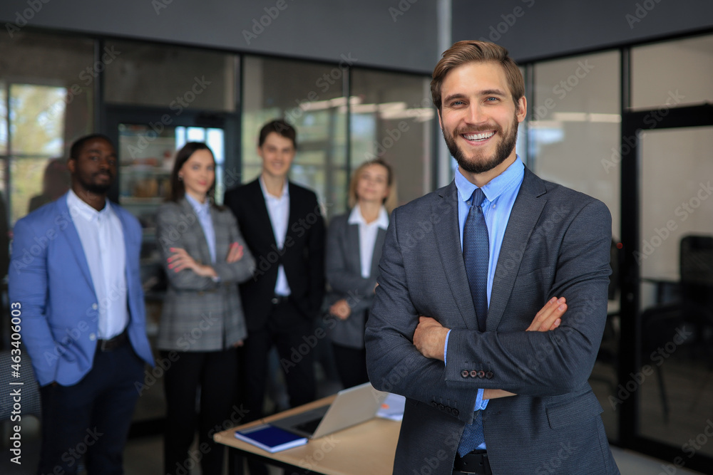 Businessman with colleagues in the background in office. Businessman with colleagues in the background in office.