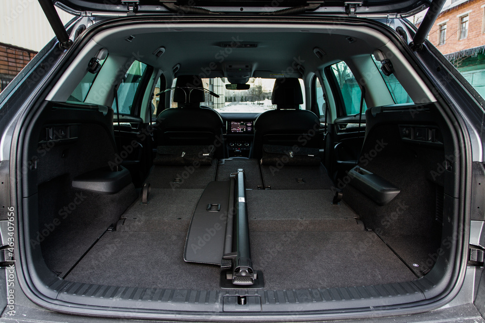 Huge, clean and empty car trunk in interior of a modern compact suv. Rear view of a SUV car with open trunk. Car trunk interior.