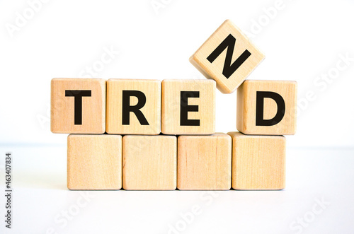 Trend symbol. The concept word 'trend' on wooden cubes on a beautiful white table, white background. Business and trend concept. Copy space.