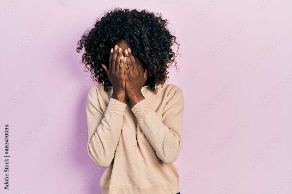 Young african american woman wearing casual clothes with sad expression covering face with hands while crying. depression concept. Young african american woman wearing casual clothes with sad expression covering face with hands while crying. depression concept.