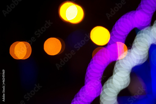 Colored blurred bokeh. abstract background of included festive garlands. colorful blur light bulbs © photosaint