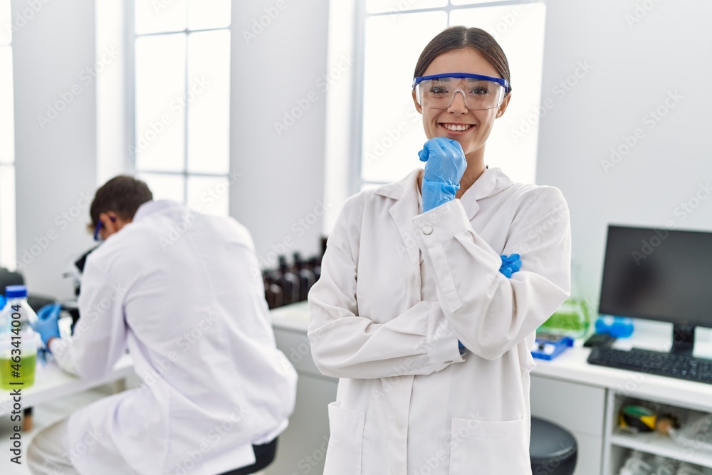 Man and woman partners wearing scientist uniform working at laboratory Man and woman partners wearing scientist uniform working at laboratory