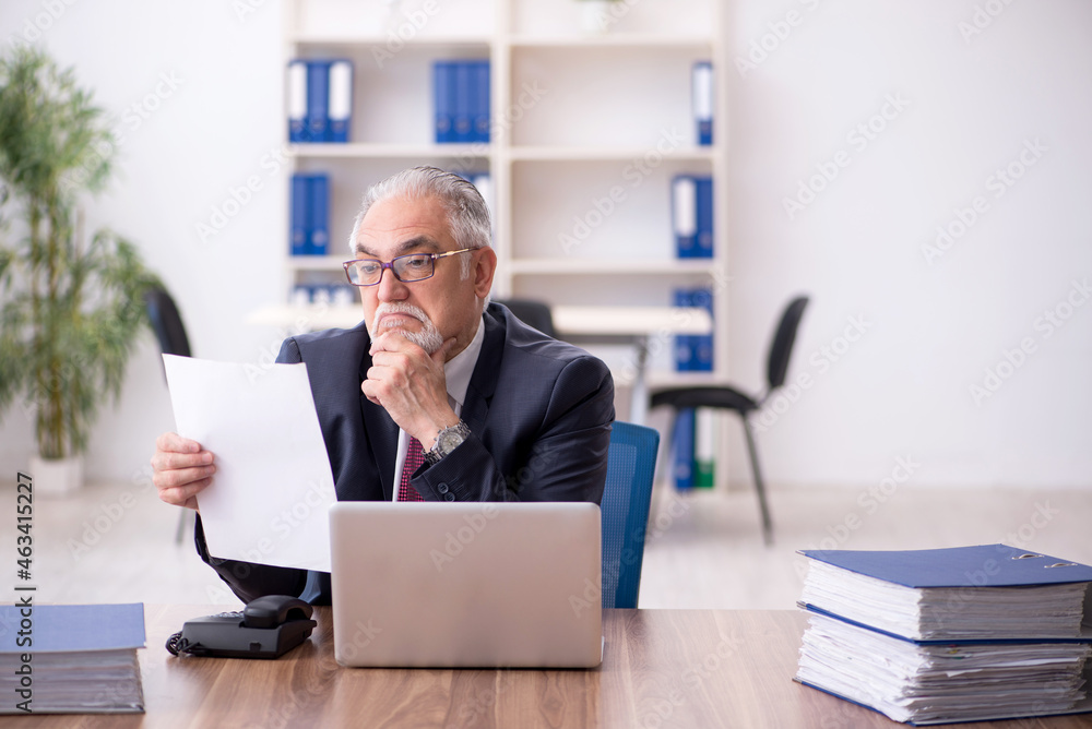 Old male employee and too much work in the office Old male employee and too much work in the office